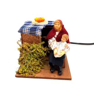 Woman rocking a cradle in motion for nativity scenes