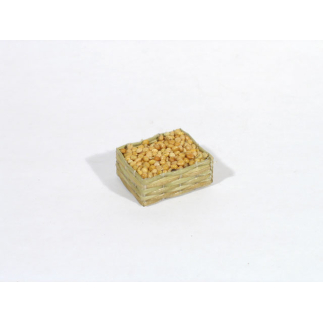 Small straw crate with light-colored seeds/clams/lentils