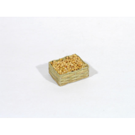 Small straw crate with light-colored seeds/clams/lentils